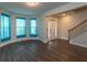 Living room featuring hardwood floors, staircase, and white trim at 600 Lockerbie Ter, Mcdonough, GA 30252