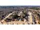 Overhead shot of a residential neighborhood featuring tree-lined streets and neatly arranged homes at 1137 Maple Creek Rdg, Loganville, GA 30052