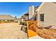 Backyard of a house with a wooden ramp leading to a deck and manicured shrubbery at 1137 Maple Creek Rdg, Loganville, GA 30052