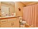 Cozy bathroom featuring a vanity, toilet, and shower with a striped curtain at 1137 Maple Creek Rdg, Loganville, GA 30052