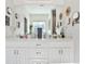 Bathroom boasts double sinks, a large mirror, and neutral tones that enhance the sense of cleanliness and brightness at 1137 Maple Creek Rdg, Loganville, GA 30052