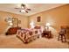 Comfortable bedroom features neutral carpet, a ceiling fan, and a cozy quilt at 1137 Maple Creek Rdg, Loganville, GA 30052