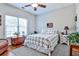 Cozy bedroom featuring hardwood floors, a ceiling fan, a window, and neutral decor at 1137 Maple Creek Rdg, Loganville, GA 30052