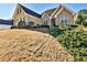 Traditional brick home with lush landscaping, a well manicured front lawn and inviting entrance at 1137 Maple Creek Rdg, Loganville, GA 30052