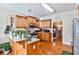 Kitchen area with wooden cabinets, bar seating, and hardwood floors at 1137 Maple Creek Rdg, Loganville, GA 30052