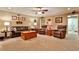 Spacious living room with plush seating, ceiling fan and bright natural light at 1137 Maple Creek Rdg, Loganville, GA 30052