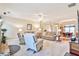 Inviting living area showcases a cozy layout with a fireplace, plush sofas, and seamless flow into the dining area at 1137 Maple Creek Rdg, Loganville, GA 30052