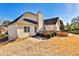 Back exterior showing patio, wooden deck, manicured bushes and spacious yard at 1137 Maple Creek Rdg, Loganville, GA 30052