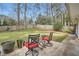 Outdoor patio with seating area, overlooking the fenced backyard with mature trees at 2334 Echo Hills Ne Cir, Atlanta, GA 30345