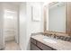 Bathroom featuring updated vanity with granite countertop and tile backsplash at 1173 Huntington Place Cir, Lithonia, GA 30058