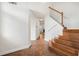 Bright foyer with wood-look tile flooring and a wood staircase leading upstairs at 1173 Huntington Place Cir, Lithonia, GA 30058