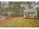 Spacious backyard with a deck, pergola, seating, and tall, mature trees at 500 Nicole Se Ct, Conyers, GA 30094