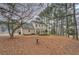 Large backyard with a patio area and a pergola, surrounded by mature trees for privacy at 500 Nicole Se Ct, Conyers, GA 30094