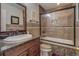 Cozy bathroom featuring granite counters, mosaic tile accents, and a glass-enclosed tub and shower at 500 Nicole Se Ct, Conyers, GA 30094