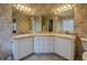 Bathroom featuring double sinks, granite countertops, and decorative wallpaper at 500 Nicole Se Ct, Conyers, GA 30094