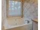 Bathroom featuring a standalone tub and tile-look wallpaper at 500 Nicole Se Ct, Conyers, GA 30094