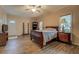 Bedroom with wood-look flooring, neutral walls, and a large window at 500 Nicole Se Ct, Conyers, GA 30094