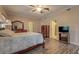 Bright bedroom with ceiling fan and a glimpse into a tiled bathroom through an open doorway at 500 Nicole Se Ct, Conyers, GA 30094
