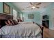Bedroom featuring two twin-size beds, wood-look flooring, and ceiling fan with lighting at 500 Nicole Se Ct, Conyers, GA 30094