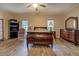 Spacious bedroom with hardwood floors, ceiling fan, and ample natural light from the two large windows at 500 Nicole Se Ct, Conyers, GA 30094