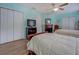 Bedroom featuring two twin-size beds, two closets, a TV, and wood-look flooring at 500 Nicole Se Ct, Conyers, GA 30094
