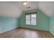 Bedroom with vaulted ceilings, a window, and wood-look floors at 500 Nicole Se Ct, Conyers, GA 30094