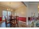 Elegant dining room featuring a chandelier, hardwood floors, and a large window for natural light at 500 Nicole Se Ct, Conyers, GA 30094