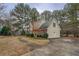 Side view of a two-story home featuring a long driveway and lush landscaping at 500 Nicole Se Ct, Conyers, GA 30094
