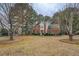 Charming two-story brick home with a well-maintained front lawn and mature trees at 500 Nicole Se Ct, Conyers, GA 30094