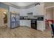 Charming kitchen showcasing white cabinets, stainless steel appliances, and modern plank flooring at 500 Nicole Se Ct, Conyers, GA 30094