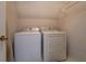Functional laundry room featuring a washer, dryer, wire shelving, and easy access at 500 Nicole Se Ct, Conyers, GA 30094