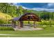 Outdoor amphitheater with stone pillars surrounded by green grass and beautiful trees at 2235 Windsor Bluffs Dr, Cumming, GA 30041