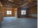 Unfinished basement with exposed wood framing and concrete floor at 2235 Windsor Bluffs Dr, Cumming, GA 30041