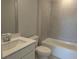 Bathroom featuring gray tiled shower, white sink with chrome faucet, and toilet at 2235 Windsor Bluffs Dr, Cumming, GA 30041