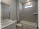 Clean bathroom with a shower-tub combo, single sink vanity, and neutral tile at 2235 Windsor Bluffs Dr, Cumming, GA 30041