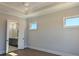 This bedroom has an open door to the bathroom and has several windows that let in a lot of sunlight at 2235 Windsor Bluffs Dr, Cumming, GA 30041