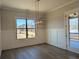 This dining room features decorative woodwork, an elegant light fixture, and a door to the deck at 2235 Windsor Bluffs Dr, Cumming, GA 30041