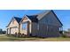 Side view of a brick and siding home showcasing large windows and professional landscaping at 2235 Windsor Bluffs Dr, Cumming, GA 30041