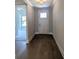Welcoming foyer features hardwood flooring, white door, and an elegant light fixture at 2235 Windsor Bluffs Dr, Cumming, GA 30041