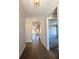 Inviting hallway with hardwood floors, white trim, and neutral paint leading to various rooms at 2235 Windsor Bluffs Dr, Cumming, GA 30041