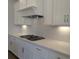 Gourmet kitchen featuring white cabinets, stainless steel appliances, custom backsplash and a gas cooktop at 2235 Windsor Bluffs Dr, Cumming, GA 30041