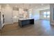 Kitchen boasts a large center island, stainless steel appliances, and recessed lighting with an open layout at 2235 Windsor Bluffs Dr, Cumming, GA 30041