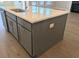 Kitchen island with stainless steel dishwasher and sink paired with quartz countertop and gray cabinets at 2235 Windsor Bluffs Dr, Cumming, GA 30041