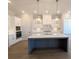 Modern kitchen featuring a center island with stainless steel appliances, quartz countertops, and custom cabinetry at 2235 Windsor Bluffs Dr, Cumming, GA 30041