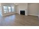Living room features hardwood floors, a modern fireplace, and abundant natural light from large windows at 2235 Windsor Bluffs Dr, Cumming, GA 30041
