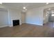 Spacious living room with a fireplace, hardwood floors, and neutral paint is ready for your personal touches at 2235 Windsor Bluffs Dr, Cumming, GA 30041