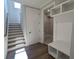 Functional mudroom includes stairs, storage bench, and access to laundry area at 2235 Windsor Bluffs Dr, Cumming, GA 30041