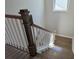 This staircase has wood treads, white risers, and a dark wood railing at 2235 Windsor Bluffs Dr, Cumming, GA 30041