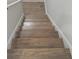 Staircase with wood steps and white risers at 2235 Windsor Bluffs Dr, Cumming, GA 30041