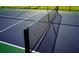 Well-maintained tennis court with net, ready for a match at 2235 Windsor Bluffs Dr, Cumming, GA 30041